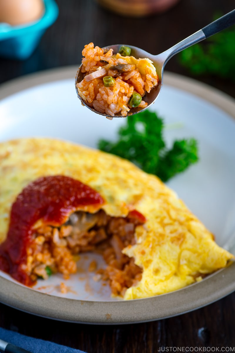 Spoon scooping up the tomato-flavored fried rice from Omurice.