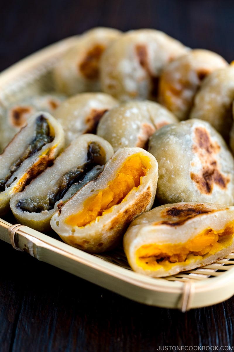 A dark plate containing Kabocha and Eggplant Oyaki (Japanese Stuffed Dumplings).