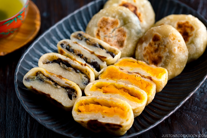 A dark plate containing Kabocha and Eggplant Oyaki (Japanese Stuffed Dumplings).