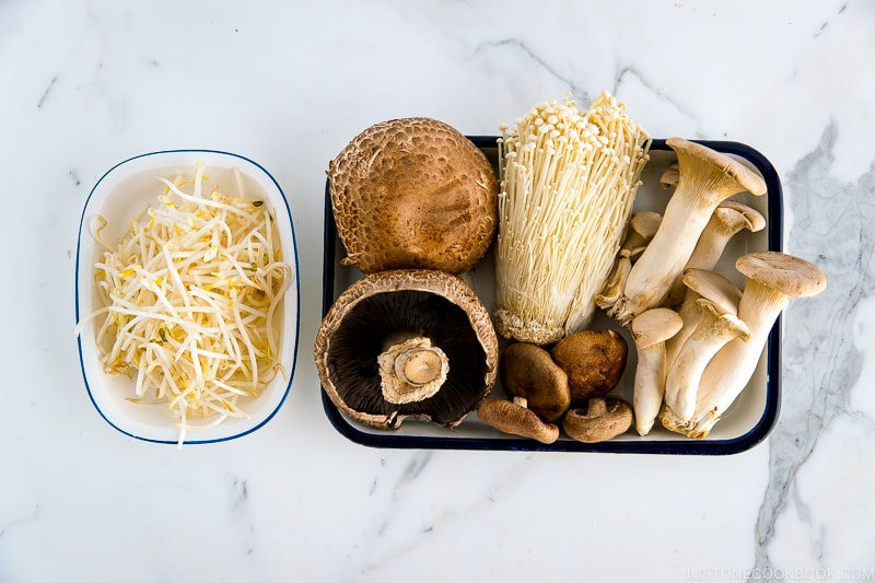 Trays of mushrooms and bean sprouts.