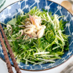 A blue Japanese bowl containing Mizuna Myoga Salad.