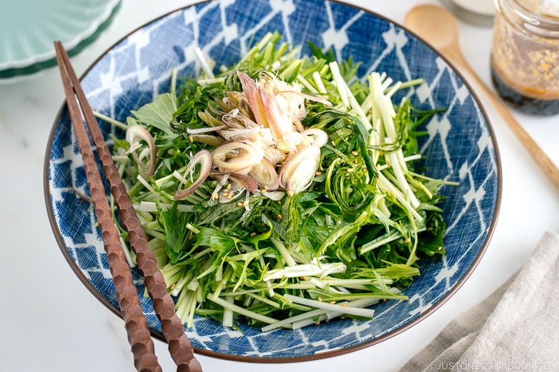 A blue Japanese bowl containing Mizuna Myoga Salad.