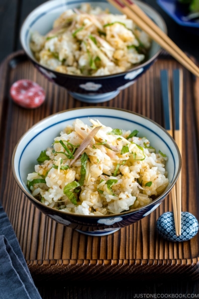 A Japanese rice bowl containing Myoga Shiso Rice (Mazegohan) served with pickled cucumber.