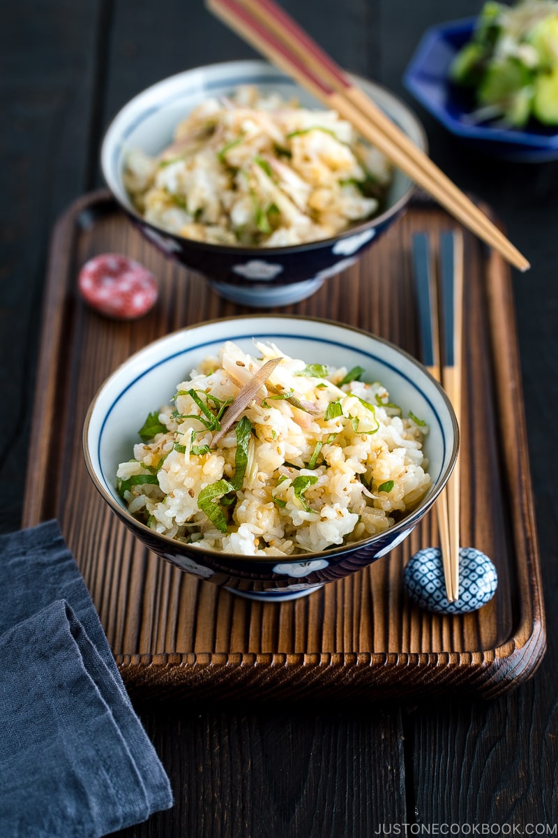 A Japanese rice bowl containing Myoga Shiso Rice (Mazegohan) served with pickled cucumber.