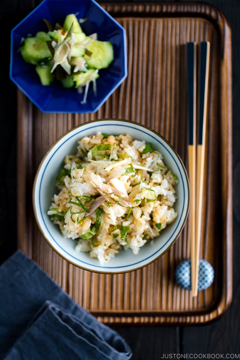 A Japanese rice bowl containing Myoga Shiso Rice (Mazegohan) served with pickled cucumber.