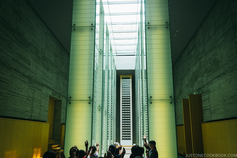 a large room with lit up columns and skylight at Nagasaki National Peace Memorial Hall for the Atomic Bomb Victims