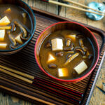 Japanese wooden bowls containing Nameko Mushroom Miso Soup.
