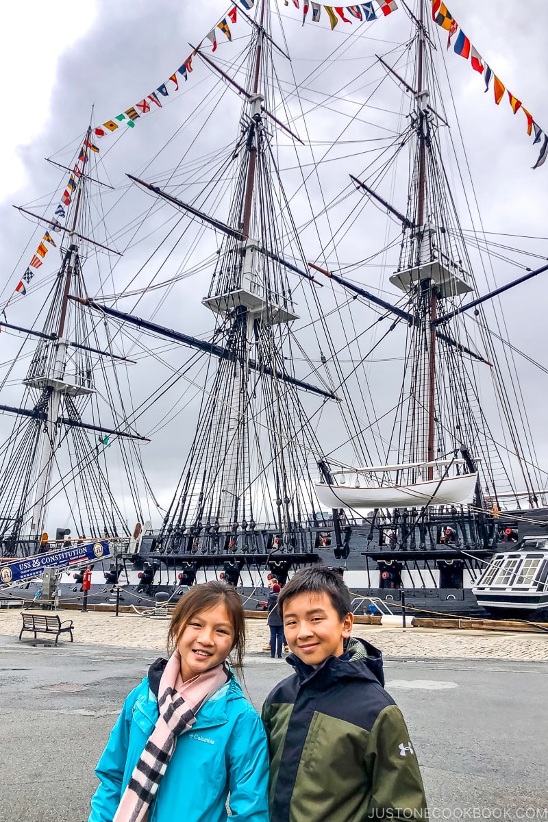 two children standing in front of USS Constitution