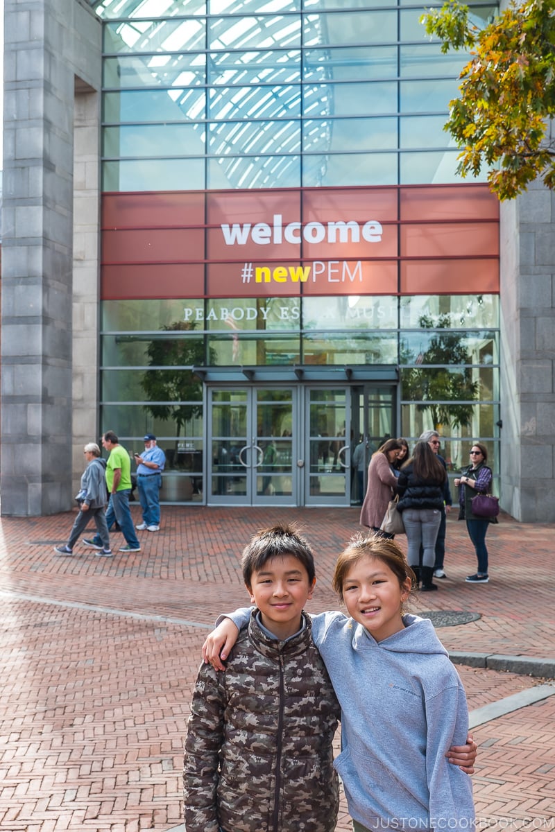 two children standing in front of Peabody Essex Museum