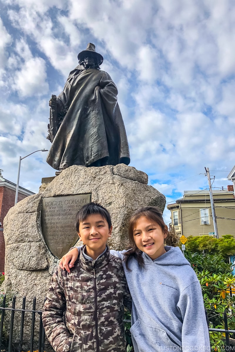 two children in front of Roger Conant statue