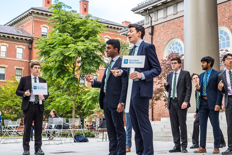 men singing at the steps of Memorial Church