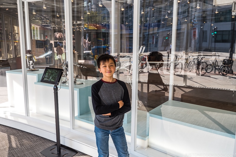 boy standing in front of exhibition at MIT Museum