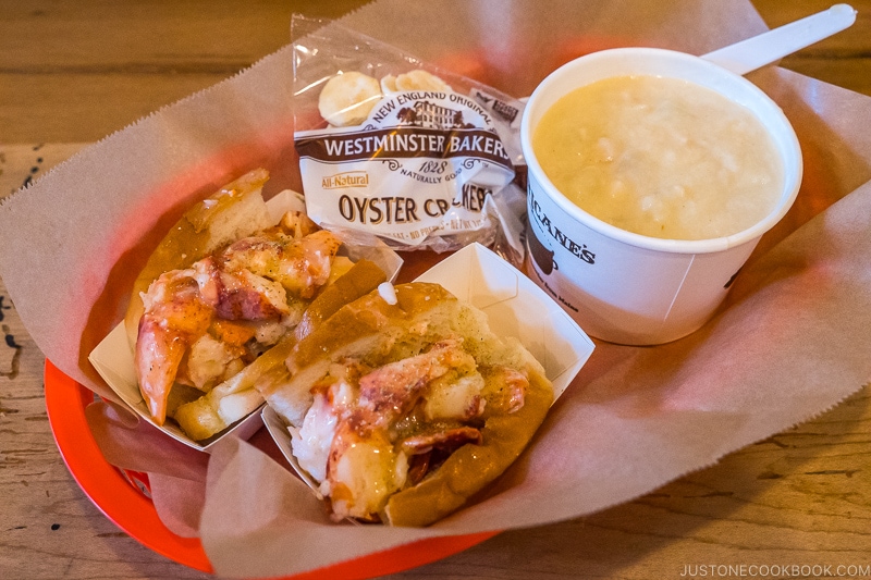 lobster roll at Luke's Lobster next to chowder on a red tray