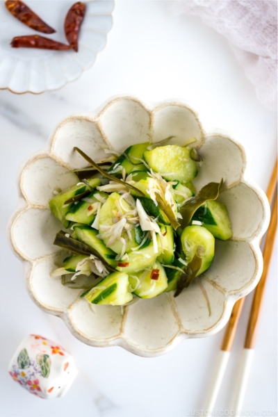 A flower shaped ceramic containing Pickled Cucumbers and Myoga.