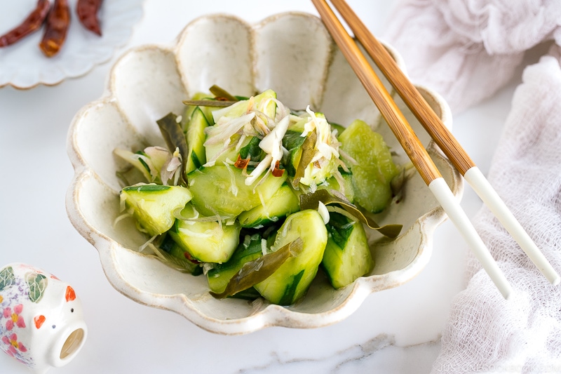 A flower shaped ceramic containing Pickled Cucumbers and Myoga.