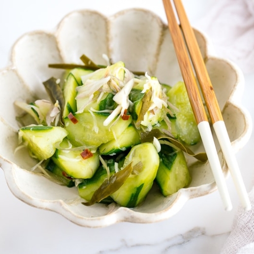 A flower shaped ceramic containing Pickled Cucumbers and Myoga.