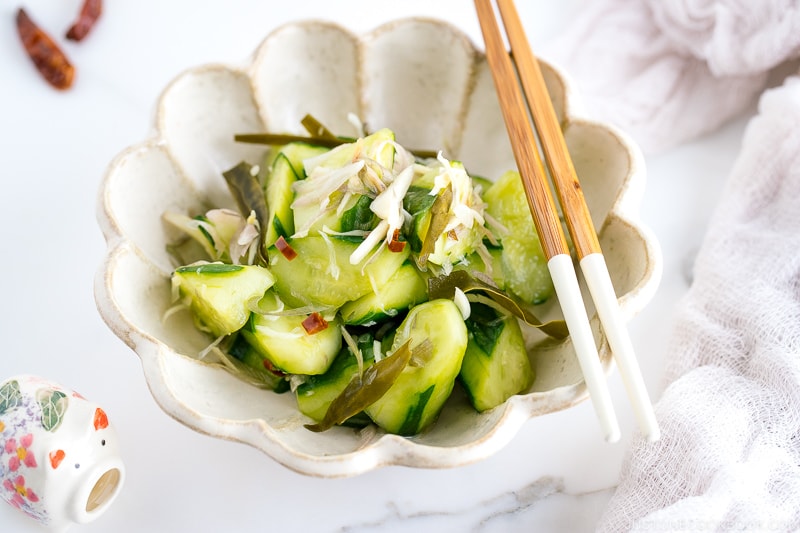 A flower shaped ceramic containing Pickled Cucumbers and Myoga.