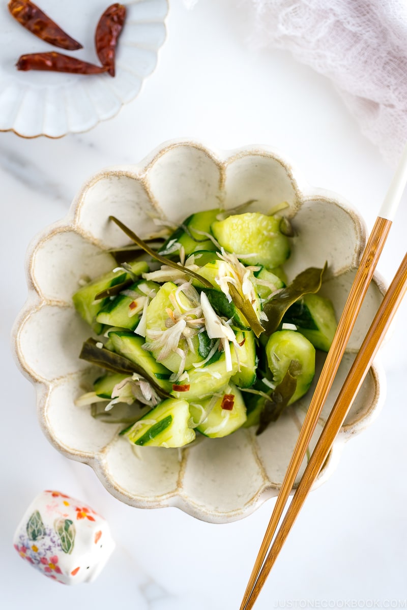 A flower shaped ceramic containing Pickled Cucumbers and Myoga.
