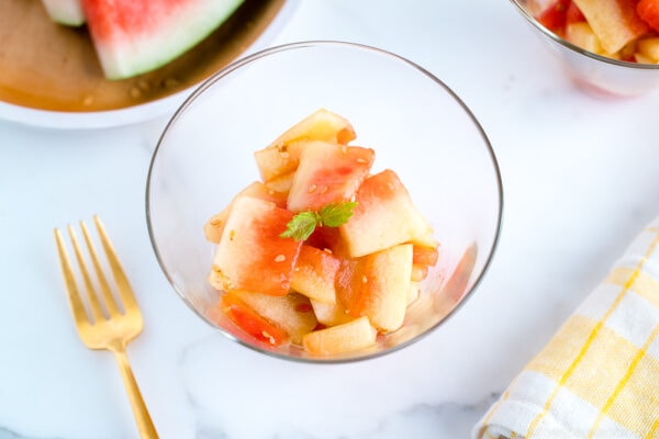 A round glass bowl containing Pickled Watermelon Rind.