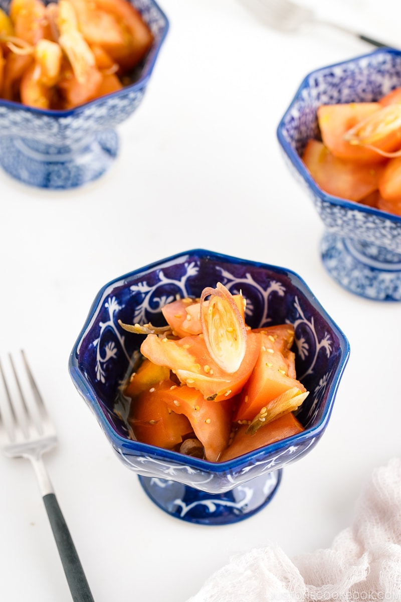 A blue and white bowl containing Tomato Myoga Salad.