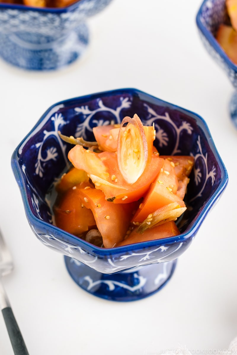 A blue and white bowl containing Tomato Myoga Salad.