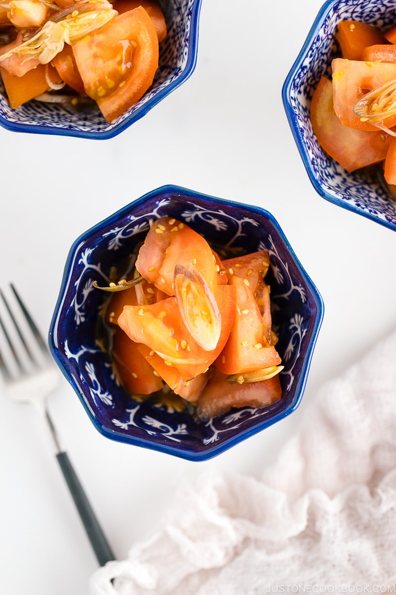 A blue and white bowl containing Tomato Myoga Salad.