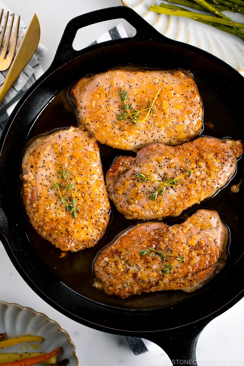 Juicy honey garlic pork chops in the cast iron skillet.