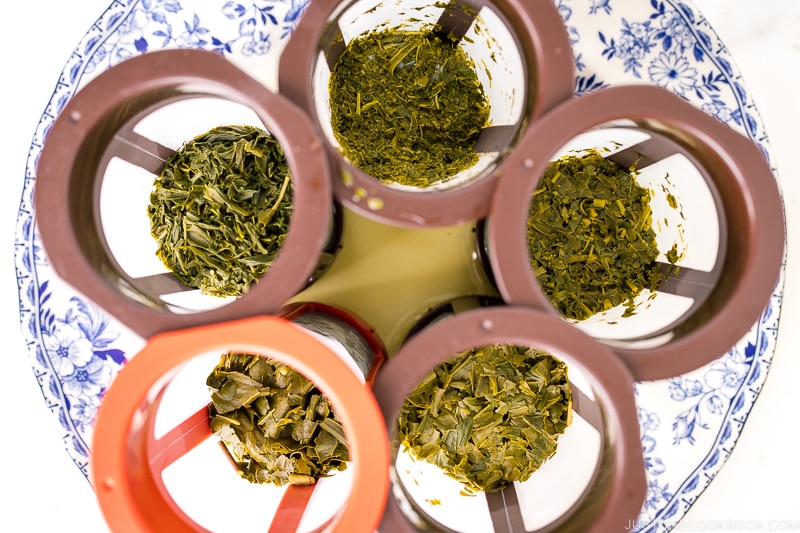 green tea leaves after brewing in 5 different tea filters