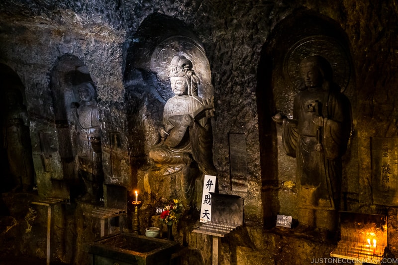 statues of deity inside a cave