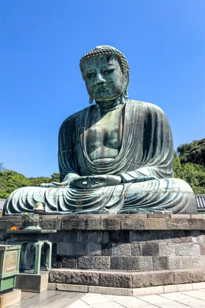 giant Buddha statue on top of stone pedestal