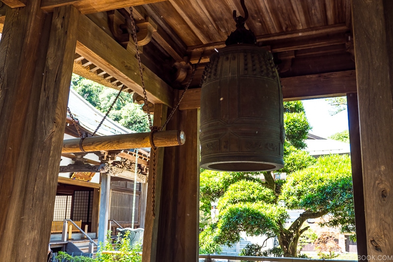 a temple bell hanging in a wooden structure