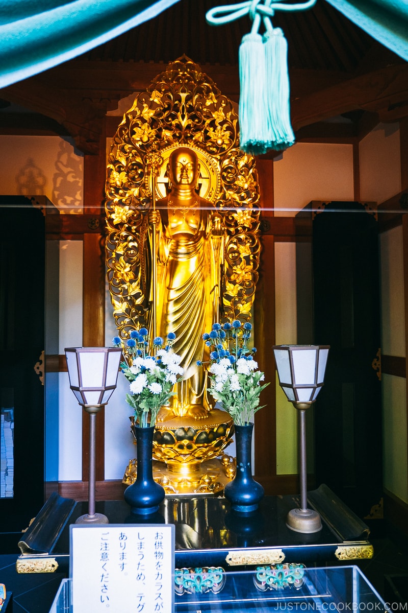 a golden deity statue inside a temple