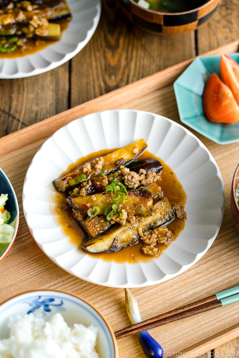 A white plate containing Mapo Eggplant (Mabo Nasu).