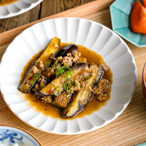 A white plate containing Mapo Eggplant (Mabo Nasu).