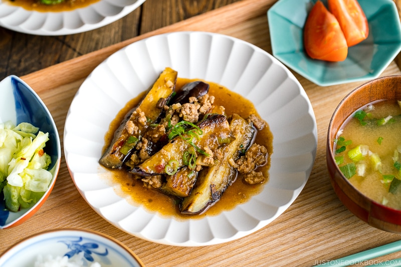 A white plate containing Mapo Eggplant (Mabo Nasu).