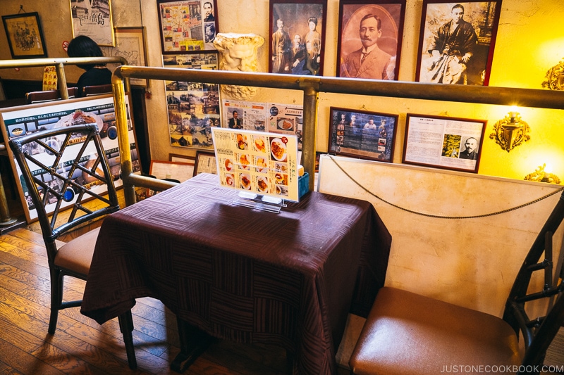 a small table with two chairs next to a handrail