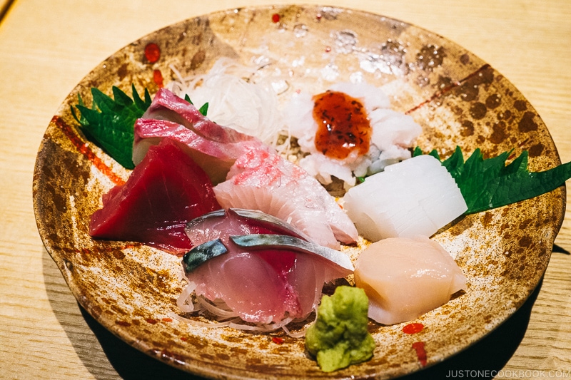 assorted sashimi on a earthenware plate