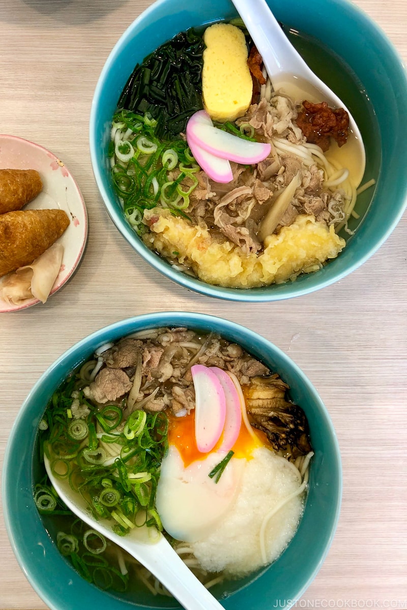 two bowls of udon noodle on top of table