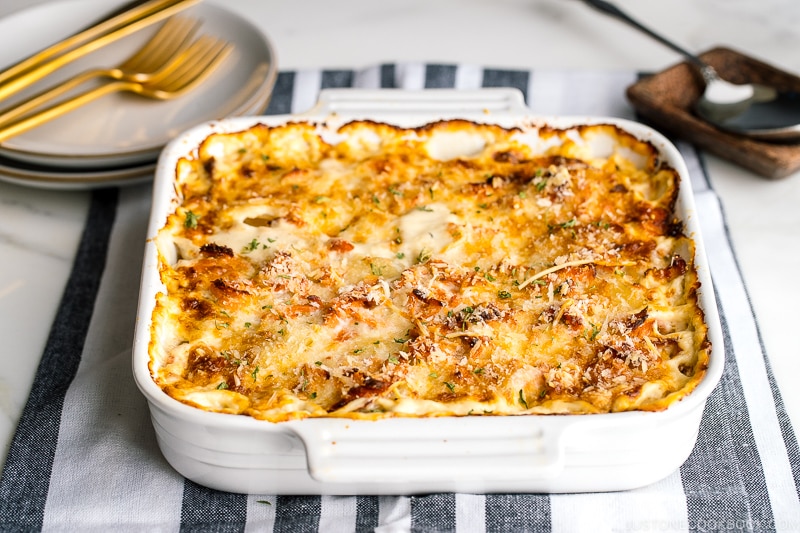 A white baking dish containing nicely charred Salmon Potato Gratin.