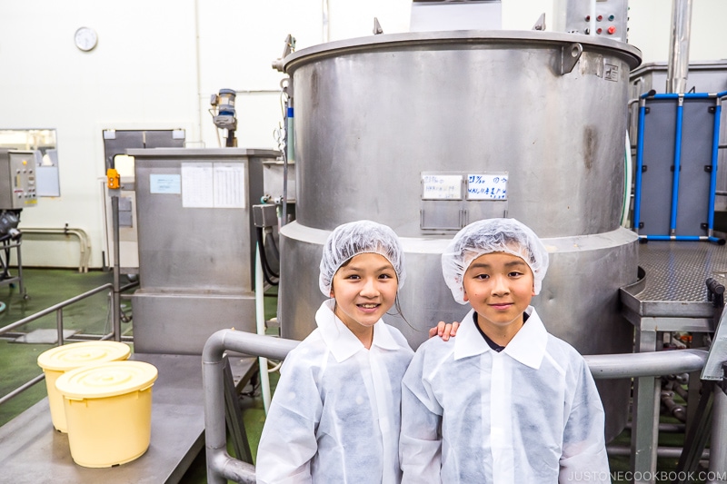 children standing in front of machines