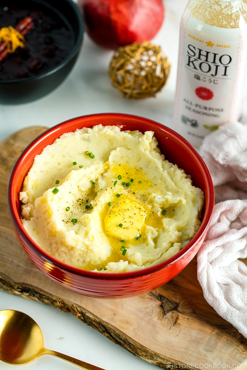 A red bowl containing Creamy Mashed Potatoes with Shio Koji.