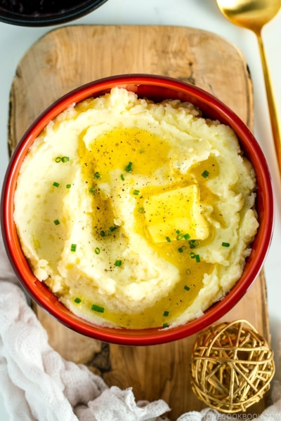 A red bowl containing Creamy Mashed Potatoes with Shio Koji.