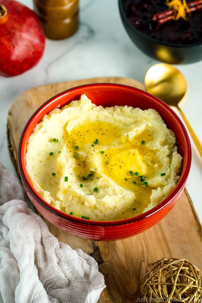 A red bowl containing Creamy Mashed Potatoes with Shio Koji.