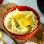 A red bowl containing Creamy Mashed Potatoes with Shio Koji.