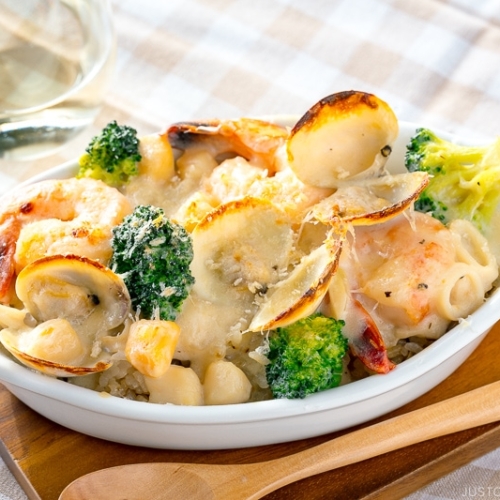 A white gratin dish containing Seafood Doria (Rice Gratin).