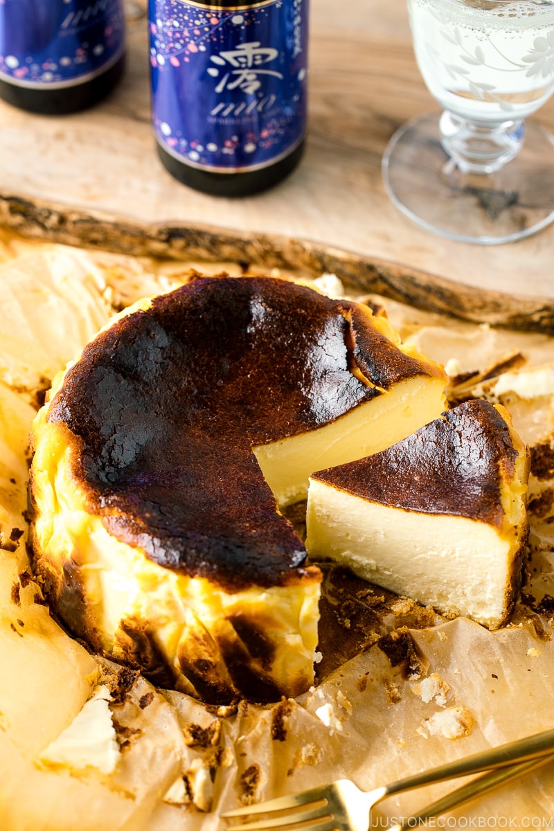 A slice of Basque Burnt Cheesecake on parchment paper.