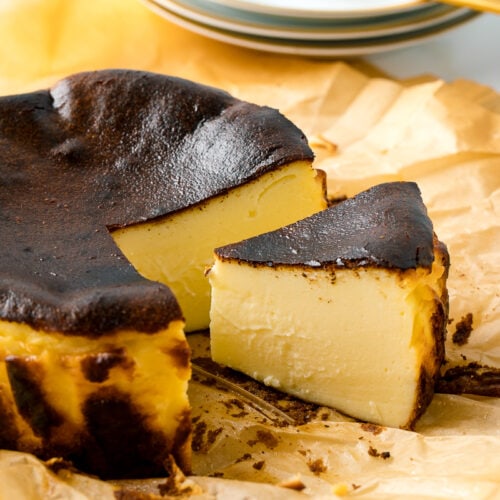 A slice of Basque Burnt Cheesecake on parchment paper.
