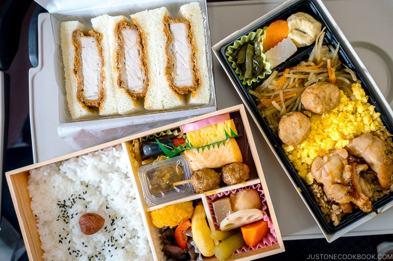 three bento boxes on a train table