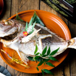 A lacquer tray containing a whole Japanese Baked Sea Bream.