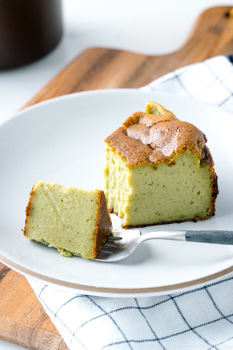 A white ceramic plate containing Matcha Basque Burnt Cheesecake.